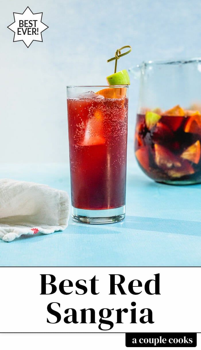 two glasses filled with red sangria next to each other on top of a table