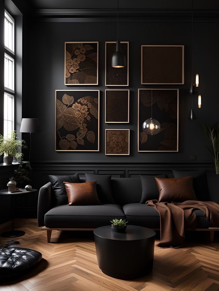 a living room with black walls and wood flooring is pictured in this image, there are pictures on the wall above the couch