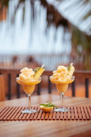 two glasses filled with food sitting on top of a wooden table