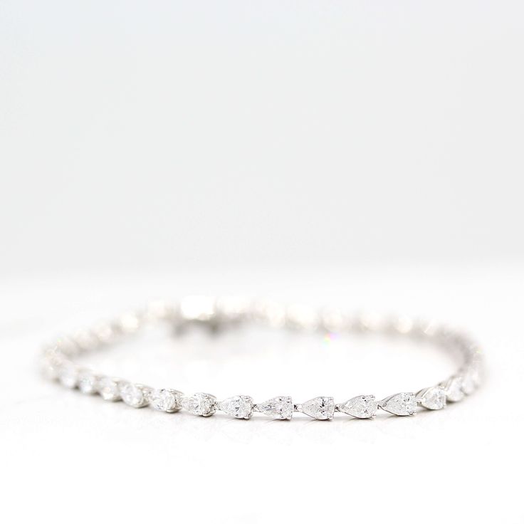 The Marquise Lab Grown Diamond Tennis Bracelet in white gold against a white background Classic Marquise Diamond Bracelet With Brilliant Cut, Diamond White Marquise Tennis Bracelet For Anniversary, Diamond Tennis Bracelet With Marquise Prong Setting, Classic Silver Marquise Diamond Bracelet, Marquise Diamond Cut Bracelets In Fine Jewelry, Silver Marquise Tennis Bracelet Fine Jewelry, Classic Marquise Diamond Bracelet In White Gold, Classic Marquise Cubic Zirconia Tennis Bracelet, Elegant Marquise Diamond White Tennis Bracelet