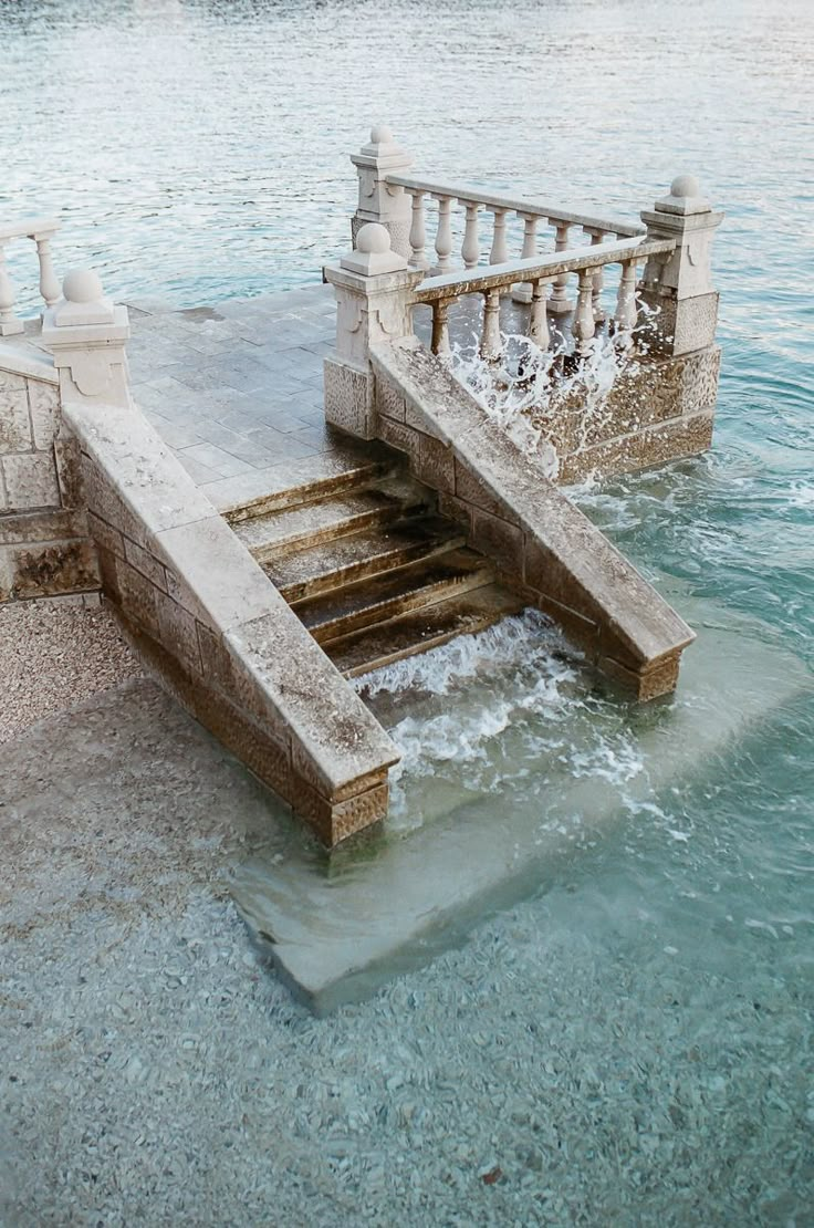 the water is splashing over the steps into the ocean