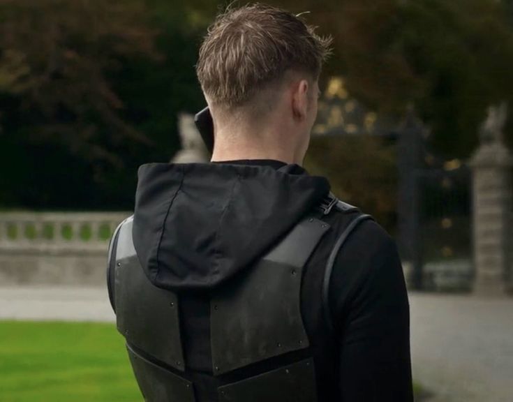 a man with a back pack on walking in the park