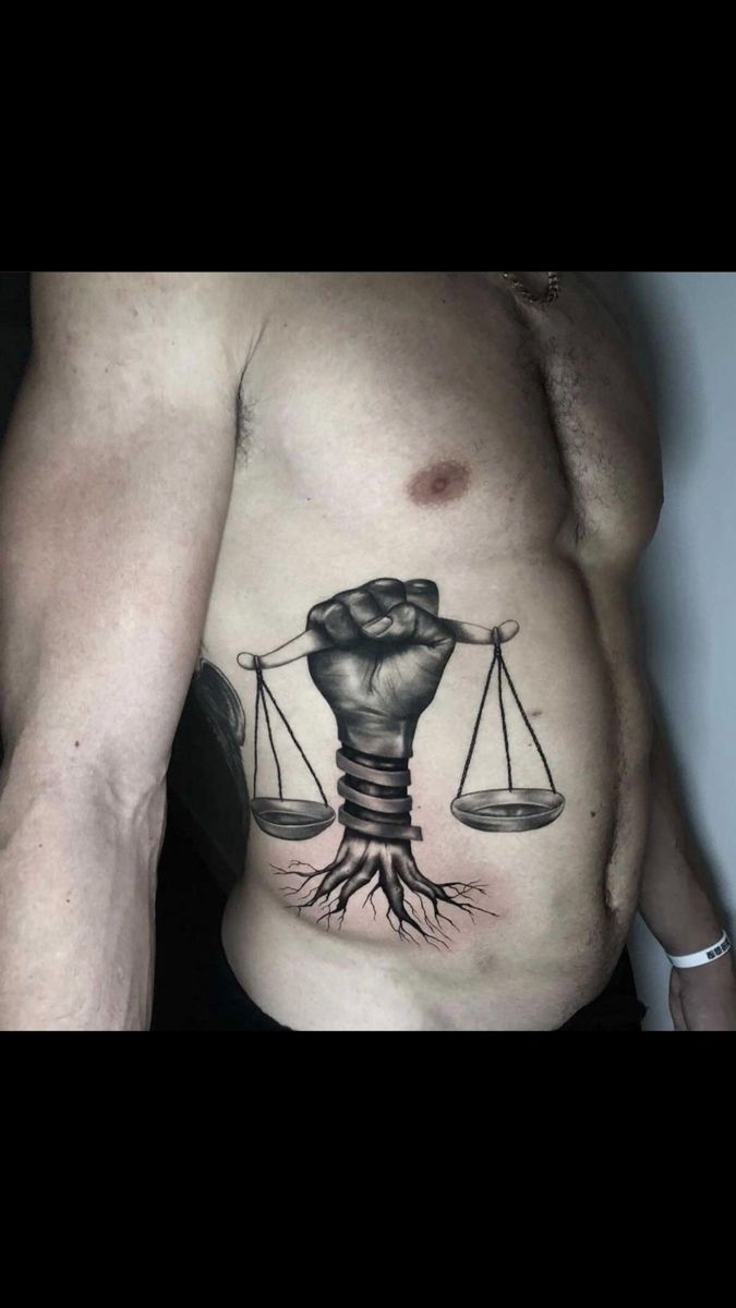 a man with a tattoo on his stomach has an image of a lightbulb