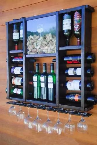 a wall mounted wine rack filled with bottles and glasses