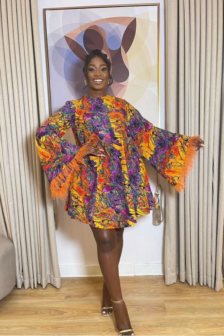 A lady wearing an Ankara fur gown Short Ankara Flare Gown Styles, Fled Gown Ankara, Short Flare Ankara Gown Styles, Lastest Style For Materials Short Gown, Flay Ankara Gown, Vintage Short Gown Styles, Akara Classic Short Gown, Flare Ankara Gown Styles, Ankara Short Gown Styles 2023