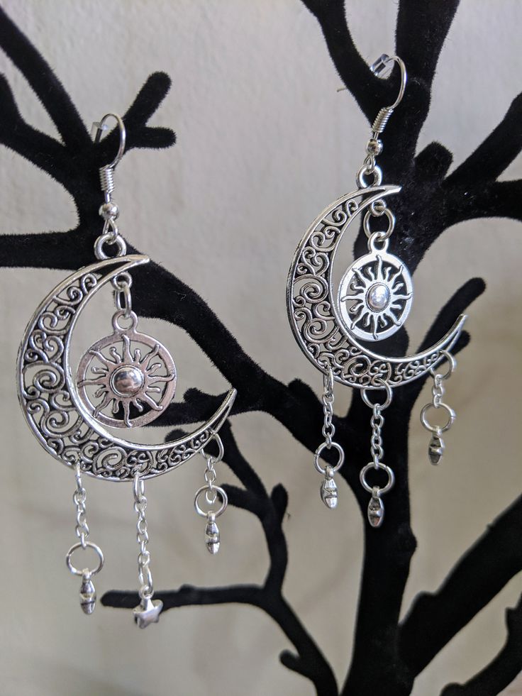 A gorgeous pair of earrings featuring earth's surrounding celestial bodies: the moon, the sun, and the stars. Choose between silver as pictured or bronze! Silver Moon-shaped Festival Jewelry, Silver Moon-shaped Jewelry For Festivals, Silver Moon Shaped Jewelry For Festivals, Mystical Metal Earrings For Festivals, Celestial Style Silver Metal Jewelry, Bohemian Crescent Sterling Silver Earrings, Bohemian Sterling Silver Crescent Earrings, Adjustable Bohemian Moon Earrings, Silver Celestial Jewelry With Sun And Moon Design