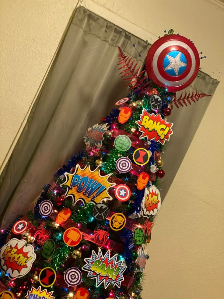 a christmas tree decorated with comic themed decorations