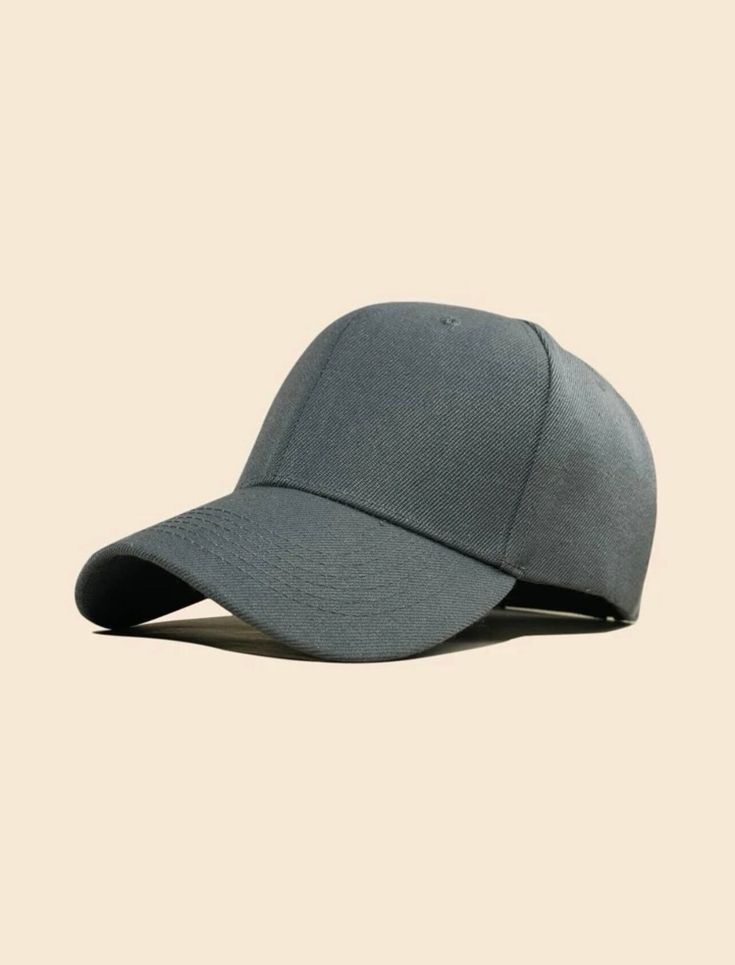 a gray baseball cap on a beige background, with the visor pulled back to reveal the peak