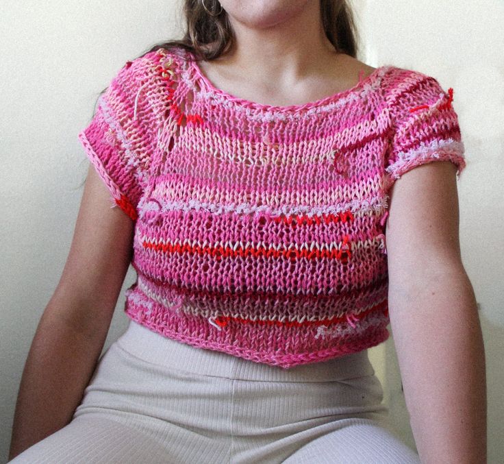 ~Free seed packet with each order!~ This funky crop top is a one-of-a-kind piece statement piece that is perfect for going to parties or wearing to brunch.  It is a light and breezy top for those warm summer nights. This top is hand knitted with zero waste scraps of yarn. - Fiber content: Acrylic, Cotton, Wool, Zero Waste Yarn/ Fiber - Size (inches): M, Shoulder to shoulder: 15; Top to bottom: 14; Bust: 17; Waist: 17 - Wash instructions: Hand wash with cold water only when necessary, lay flat to dry. Spot cleaning recommended when necessary to improve longevity of garment. Spring Vacation Crew Neck Crop Top, Playful Red Summer Tops, Playful Red Tops For Summer, Fun Red Summer Tops, Fun Cotton Crop Top For Spring, Fun Fitted Crop Top For Spring, Spring Beach Crop Top With Crew Neck, Playful Summer Crop Tops, Playful Crop Top For Summer