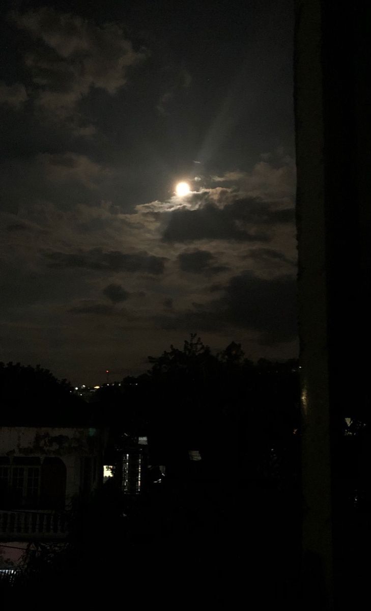 the moon is shining brightly in the night sky