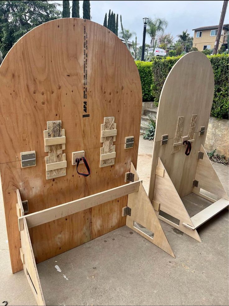 two wooden doors are open and ready to be used as an outdoor storage area for skateboards