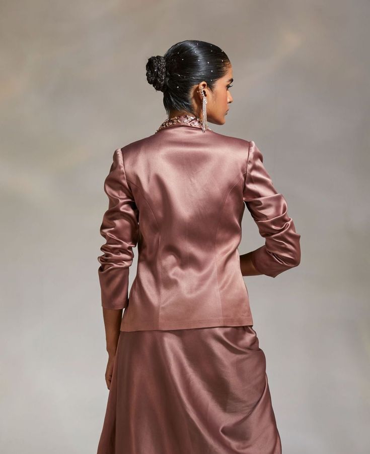 Editor's Note Style a traditional look with a solid lapel jacket with hand embroidery detailing Note: Blouse and skirt worn by model is for styling purposes only. Color: Mauve Fabric: Heavy Satin Fit type: Tailored Components: Jacket Occasion: Party Care: Dry Clean Only About the Designer The crux and essence of the label, Divya Aggarwal, is to challenge and revamp the face of ordinary traditional wear while being customer oriented. Driven by the values of individuality and creativity, this cont Divya Aggarwal, Mauve Fabric, Blouse Yoke, Personal Shopping Service, Notes Style, Embroidery Detailing, Lapel Jacket, Traditional Wear, Modern Vibe