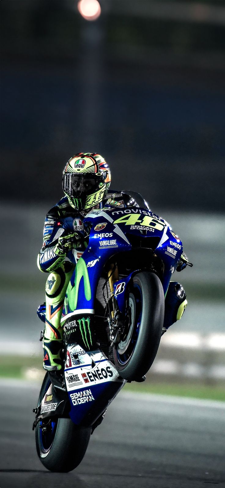 a person riding a motorcycle on a race track