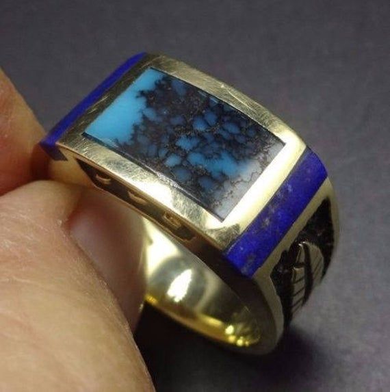 "VINTAGE NAVAJO GOLD & TURQUOISE RING DESCRIPTION: This exquisite ring features perfect inlay of tightly webbed turquoise, flanked with deep blue Lapis, on a foundation of heavy gauge 14 karat gold. This ring will be a treasured addition to your collection of the very finest vintage Native American jewelry. MEASUREMENTS: Ring face measures 7/16\" at the widest RING SIZE: 10 1/4 WEIGHT: 12.8 grams SIGNED: yes, but unreadable GOLD: yes, stamped 14K" Collectible Blue Multi-stone Turquoise Ring, Collectible Blue Turquoise Inlay Ring, Yellow Gold Inlay Jewelry For Anniversary, Yellow Gold Turquoise Ring With Polished Finish, Antique Blue Multi-stone Jewelry, Rectangular 14k Gold Collectible Jewelry, Unique Rectangular Inlay Jewelry, Collectible Multi-stone Blue Turquoise Ring, Vintage Blue Turquoise Ring Engraved