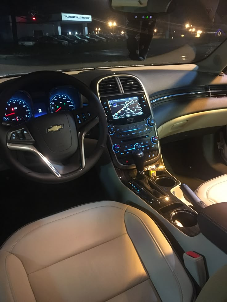 the interior of a car with dashboard lights on