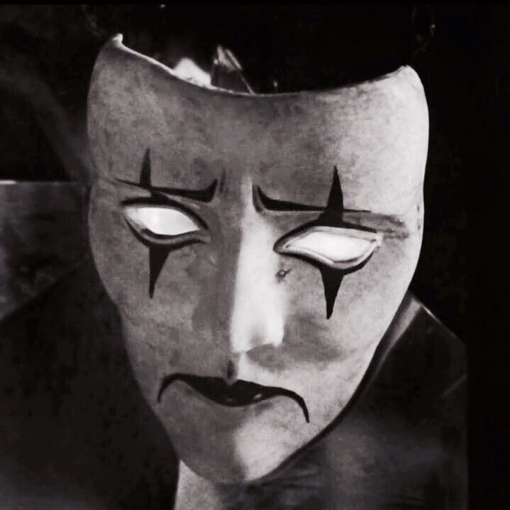 a creepy mask with eyes and nose painted on it's face is shown in black and white