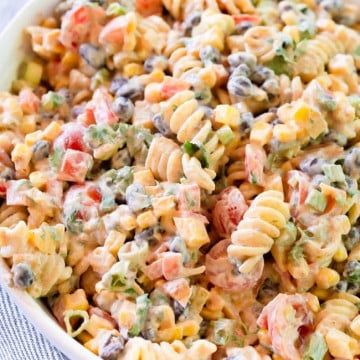 a bowl filled with pasta salad on top of a table