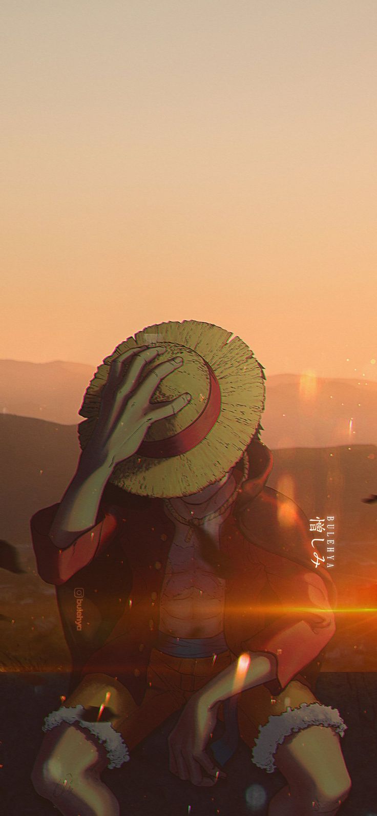 a woman sitting on the ground wearing a hat