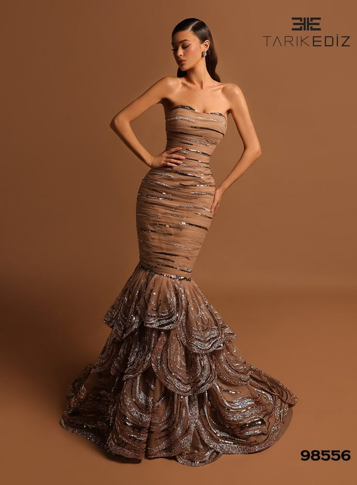 This strapless gown is perfect for a glamorous night out. The ruched bodice and sequined fabric will draw eyes your way as you walk into the party. The mid-open back and sweep train lend an air of old-school Hollywood glamor, while the ruffled tier skirt adds a playful touch. Simply pair with matching heels and jewel-t Classy Dress Couture Candy, Luxury Couture Gown For Prom Season, Classy Formal Dresses Couture Candy, Luxury Elegant Dresses For Red Carpet, Long Formal Dresses Elegant Couture Candy, Formal Long Dresses Elegant Couture Candy, Luxury Elegant Formal Ball Gown, Luxury Dresses For Gala Holiday, Gowns Dresses Elegant Classy Couture Candy