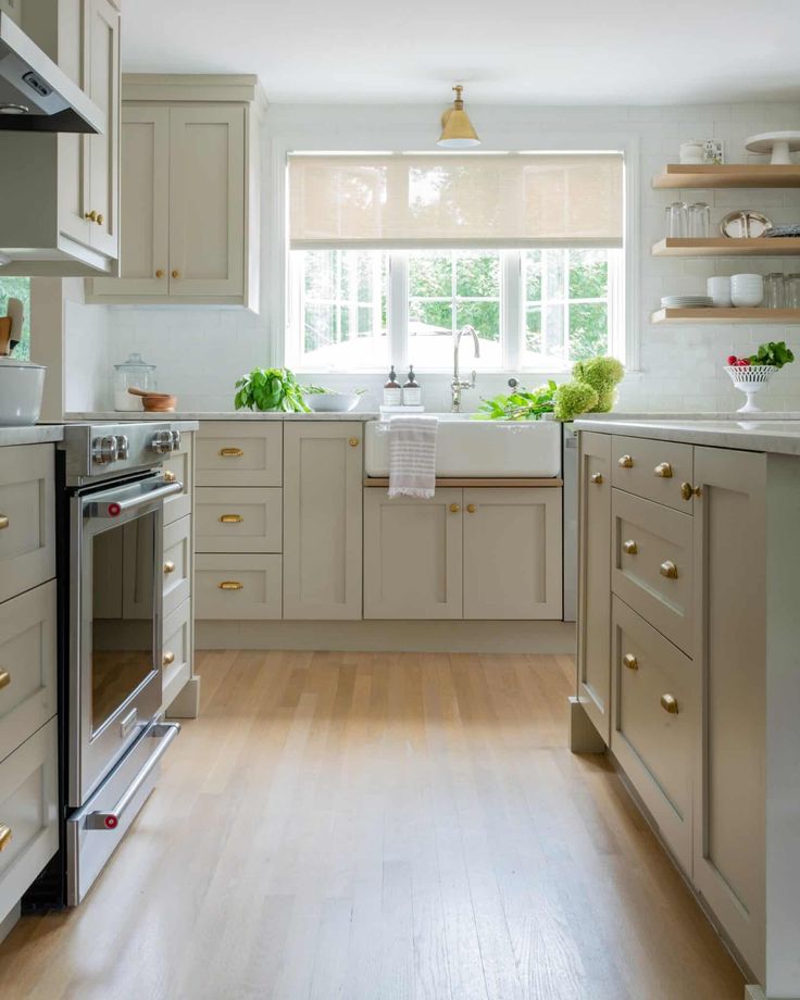 a kitchen with wooden floors and white cabinets