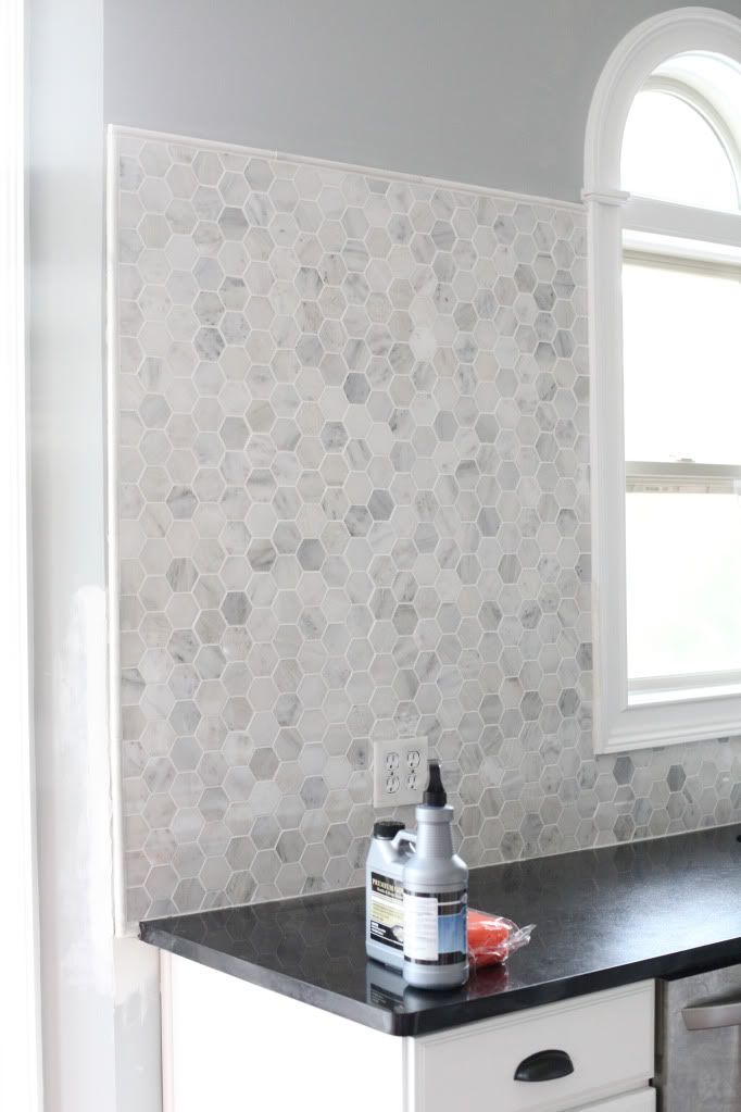 a kitchen counter with a spray bottle on it