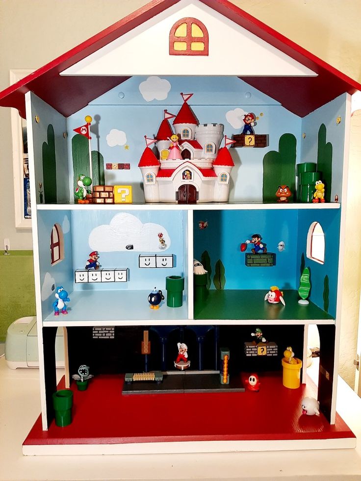 a doll house with lots of toys on top of it's shelves in a room