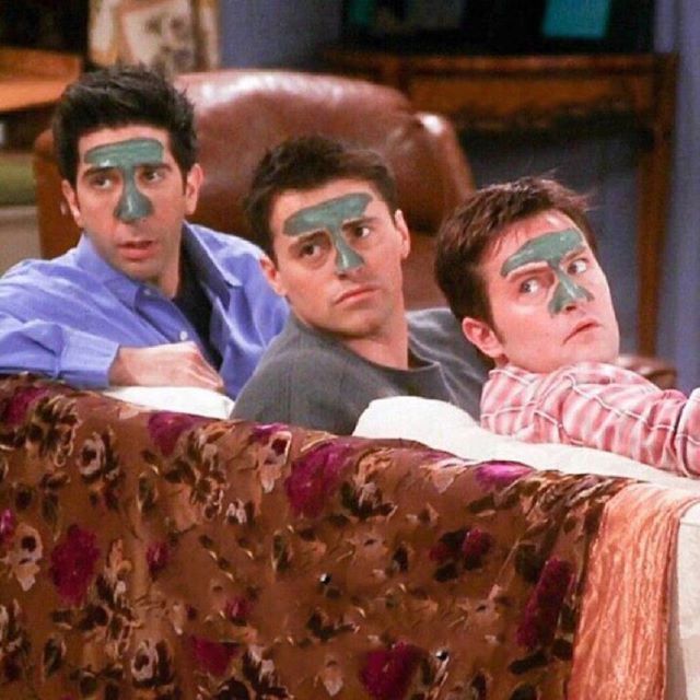 three young men with their faces painted to look like they are lying on a couch