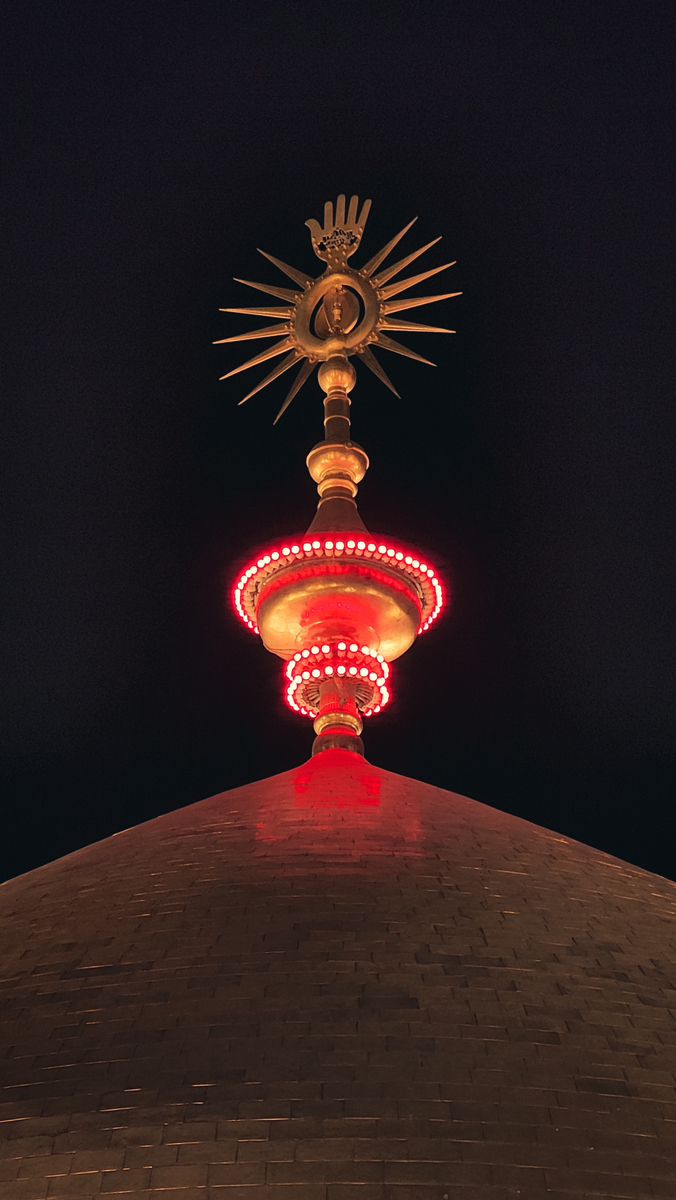 the top of a building lit up at night