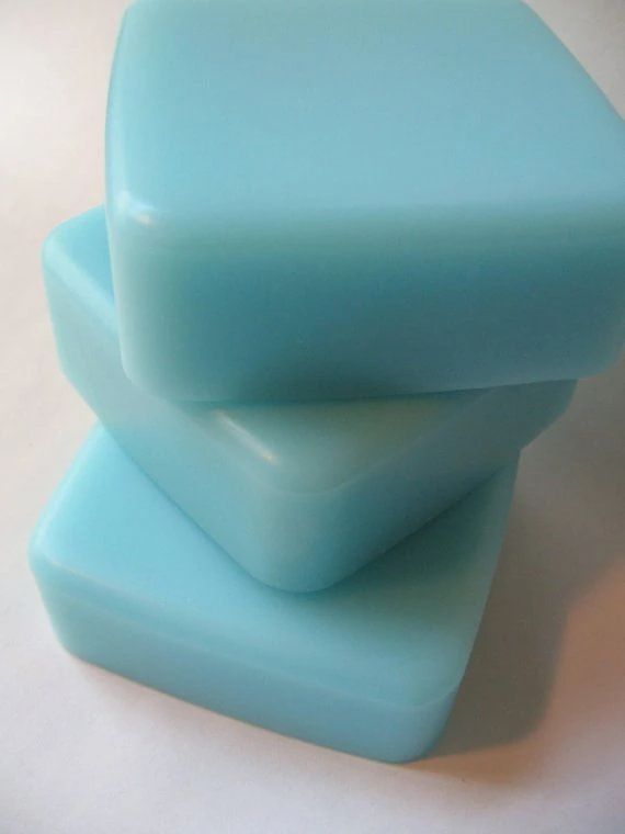 three pieces of blue soap sitting on top of each other