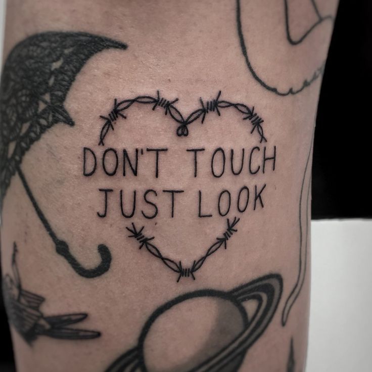 a tattoo that says don't touch just look