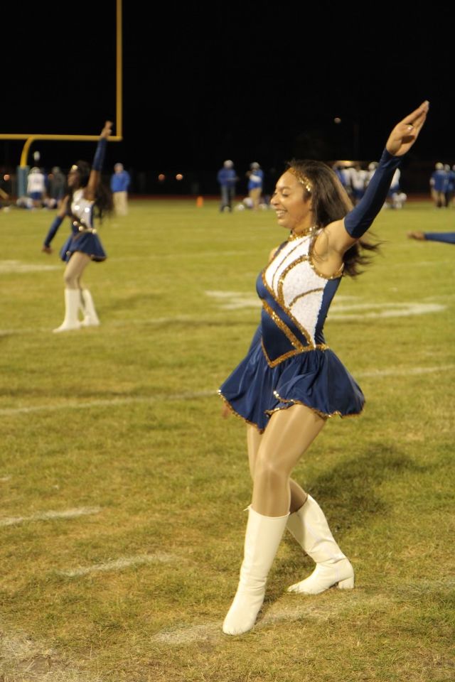 a cheerleader is dancing on the field