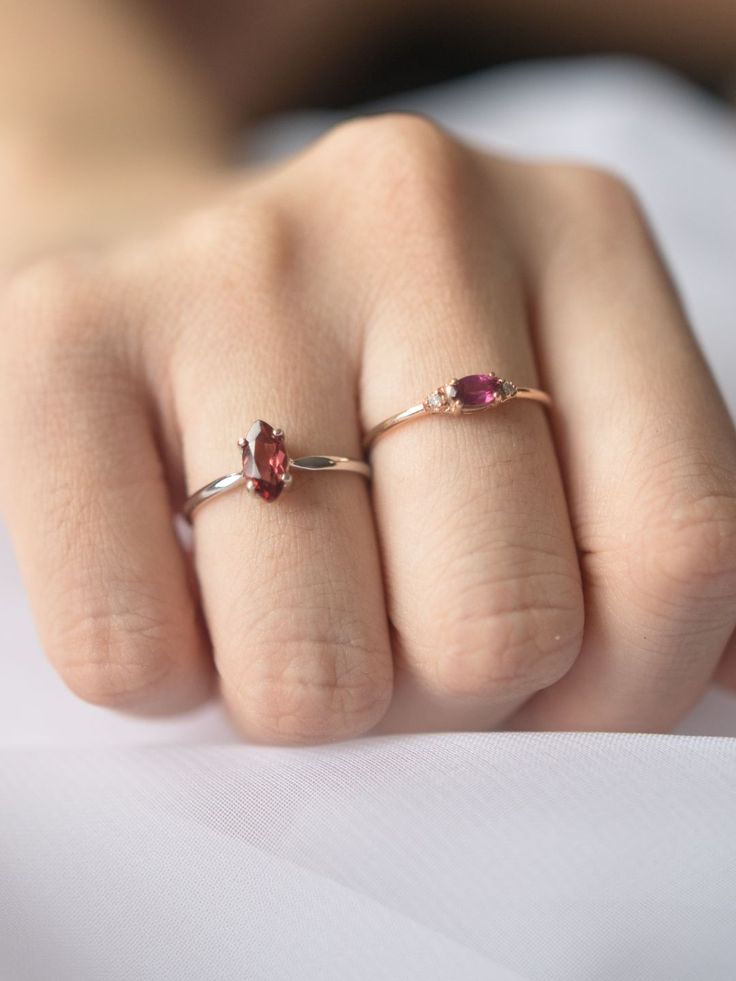 Our Buttonsage Solitaire Ring is set with a rich-colored garnet with beautiful mix of red and pink, this ring will attract the bees and butterflies trailing behind in a bewitching display of colors. Oval Ruby Ring In 14k Rose Gold, 14k Rose Gold Jewelry With Red Gemstone, Rose Gold Garnet Gemstone Ring, Elegant Garnet Crystal Ring With Gemstone, Rose Gold Ruby Tourmaline Ring, Red Garnet Marquise Ring, Red Garnet Solitaire Ring, Red Tourmaline Gemstone Ring, Marquise Garnet Red Rings