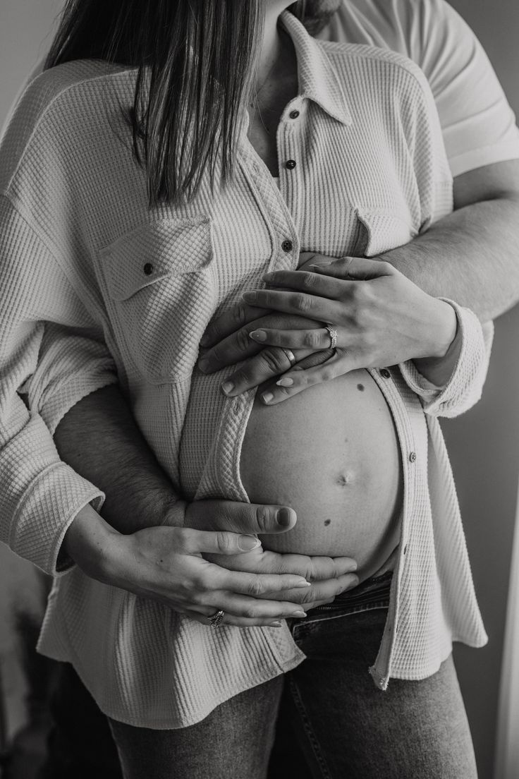 a pregnant woman is holding her stomach