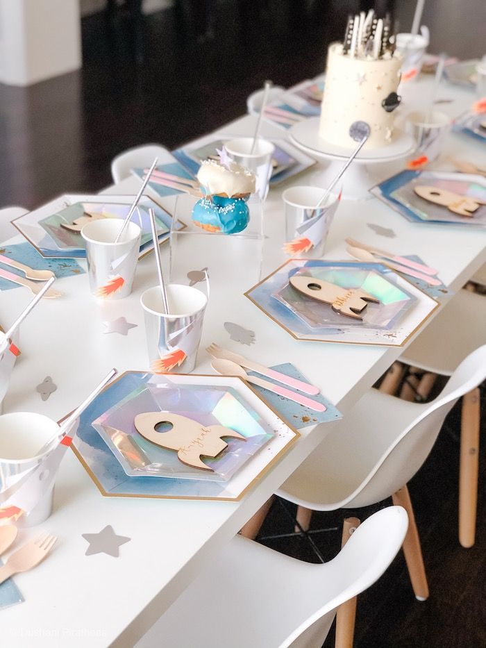 a long table with plates and cups on it