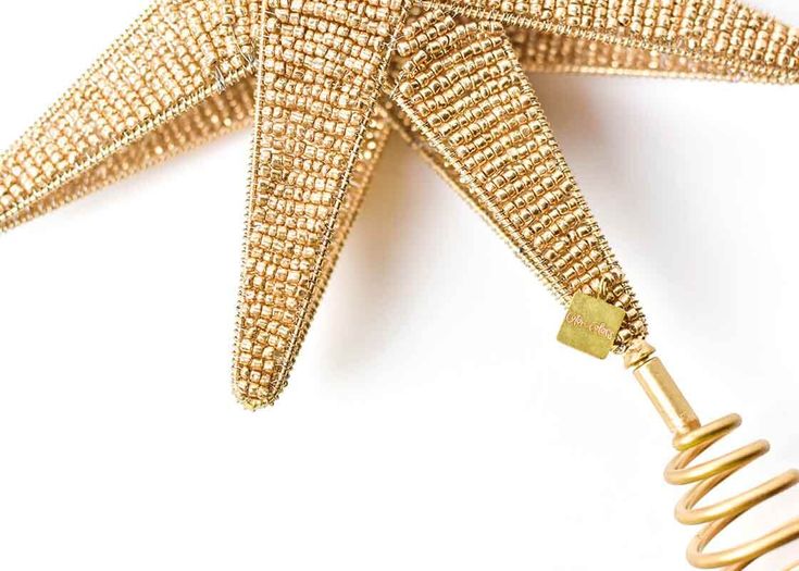 a golden star shaped object with a key attached to it