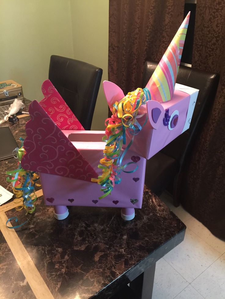 a pink unicorn shaped box on top of a table