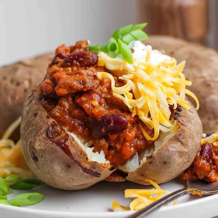 baked potato stuffed with chili and cheese on a plate