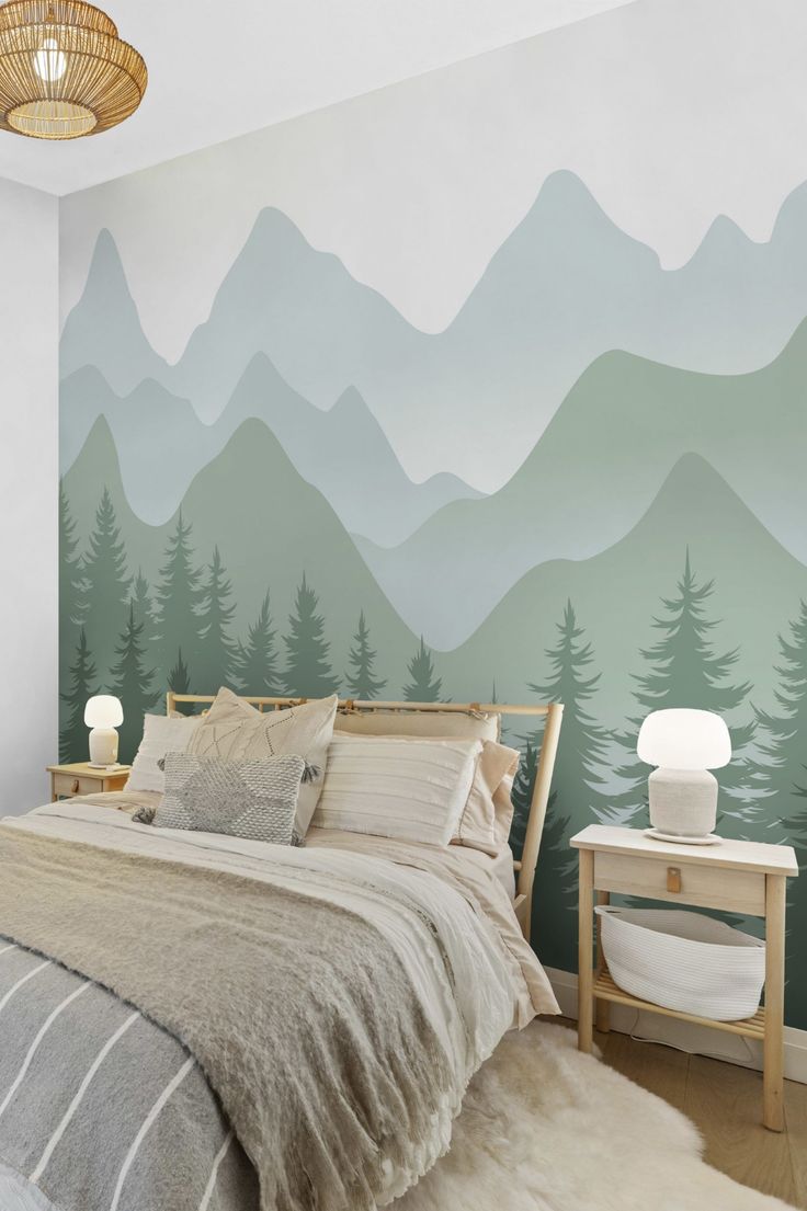 a bedroom with mountains painted on the wall and a bed in front of it,