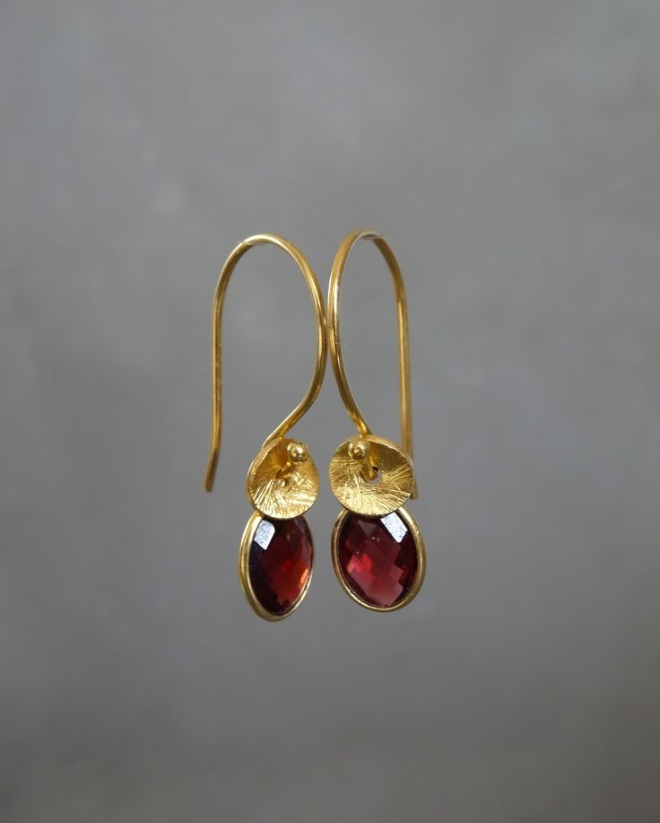 "These beautiful 24k gold vermeil earrings feature a genuine faceted garnet and twisted textured bead. Vermeil is a thick coat of 24 karat gold on solid sterling silver. Garnet is the birthstone for January. These earrings would make a perfect gift for any occasion. Total length: 2.7 cm (1\") Width: 7 mm The earrings will come in a beautiful gift box. * CHECK OUT MORE JEWELLERY * www.etsy.com/shop/kailajewellery" Gold Garnet Teardrop Earrings, Gold Teardrop Garnet Earrings, Gold Garnet Dangle Earrings, Elegant Gold Garnet Earrings, 22k Gold Hammered Earrings As Gift, Hammered 22k Gold Earrings As Gift, Red 22k Gold Earrings For Gift, Gift Hammered Earrings In 22k Gold, Gold Faceted Garnet Earrings