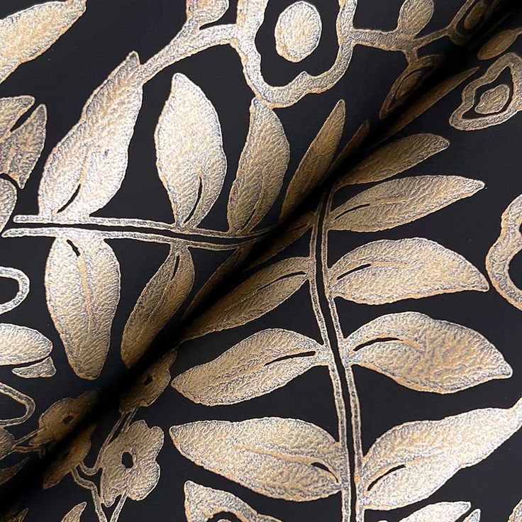 a black and gold wallpaper with leaves on it