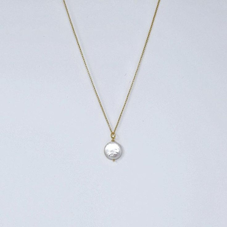 MVP's best selling necklace features a large iridescent coin pearl on a 14k gold filled rope. It's simple, striking, and makes a great gift. Materials 12-14 mm round white freshwater coin pearl with undertones of champagne, ivory and pink; 14k gold-filled chain, magnetic clasp.Size18" All jewelry is handmade by me in my Florida home studio. Orders ship free, and arrive gift wrapped and ready for giving. Please allow 1-3 business days for production. Elegant Adjustable Round Medallion Necklace, Elegant Round Medallion Necklace, Elegant Adjustable Medallion Necklace With Coin Pendant, Elegant Coin Pendant Medallion Necklace, Elegant Adjustable Coin Pendant Medallion Necklace, Pearl Charm Coin Necklace Gift, Elegant White Coin Necklace With Round Pendant, Elegant White Round Pendant Coin Necklace, Yellow Gold Medallion Necklaces With Pearl Charm