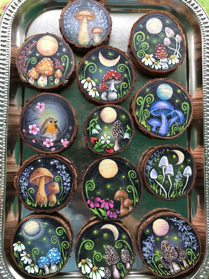 there are many decorated cupcakes in the tray on the table with different designs