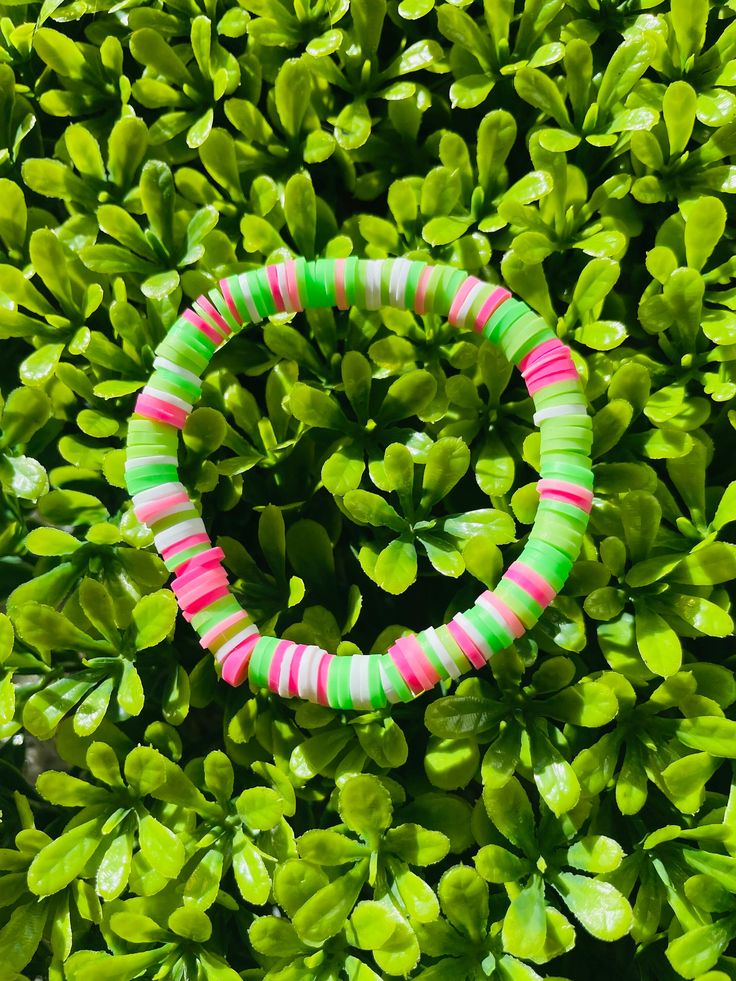 A pink, green, and white clay bead bracelet that is unique but also simple enough to wear with any outfit! *All bracelets are 6.5 - 7 inches, but if custom size is needed, please leave a message or add a note*   You can also mix and match with other bracelets from my shop to create a bracelet stack that suits your style:) All bracelets are.... --------------------------- - Comfortable  - Durable - Stretchy - Colorful - Waterproof ---------------------------- Please contact me at baforsyt11@gmail.com if bracelets arrive damaged or is too small/big. Also feel free to contact me if you would like a custom size, colors, design, or name added to the bracelet:) ( no extra charge )  CARE TIPS ----------------------------------------------------------- - Roll or lightly stretch to get of wrist - D Fun Green Beaded Bracelets, Fun Green Beaded Bracelets With Round Beads, Fun Green Beaded Stretch Bracelet, Fun Green Bracelets With Round Beads, Green Beaded Fun Stretch Bracelet, Fun Green Round Beaded Bracelets, Green Beaded Stretch Bracelet Fun Style, Green Heishi Beaded Colorful Friendship Bracelets, Handmade Green Heishi Beads Bracelets