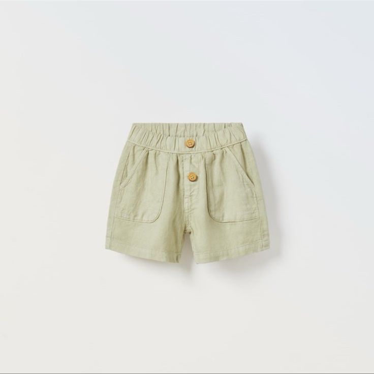 Shorts With Elastic Waistband And Front Button Appliqu. Front Pockets And Back Patch Pockets. Fabric Is 55% Linen. Size 3-4 Years Light Green Cute Summer Pants With Pockets, Cute Cotton Bottoms With Buttons, Green Shorts With Pockets For Playwear, Summer Short Pants With Buttons, Casual Cotton Shorts With Buttons, Green Bottoms With Pockets For Playwear, Short Playwear Shorts With Pockets, Short Shorts With Pockets For Playwear, Spring Playwear Bottoms With Pockets