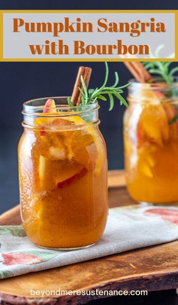 two mason jars filled with pumpkin sangria with bourbon