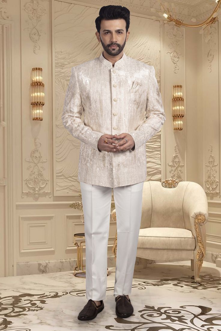 Indulge in the exquisite luxury of our Mens Bandhgala M42-S79, adorned with beautiful Cutdana and sequence detailing. Experience the sophistication and exclusivity of our premium product, designed to elevate your style and make a statement. Elevate your wardrobe with this tasteful piece. Elegant Dabka Sets For Reception, Elegant Sets With Dabka Detail For Reception, Elegant Sets With Dabka For Reception, Embellished Sherwani For Wedding And Diwali, Elegant Traditional Wear With Dabka For Reception, Embellished Sherwani For Wedding And Festivals, Wedding Sherwani Embellished For Festivals, Elegant Party Sets With Pallu Detail, Festive Silver Wedding Kurta