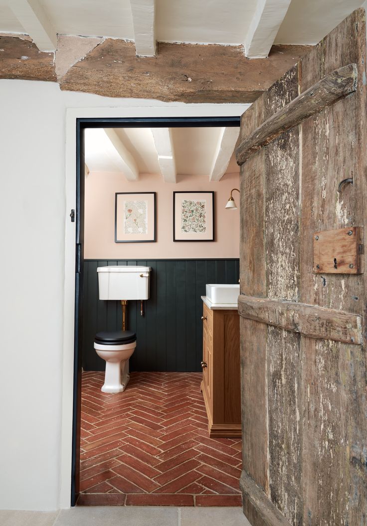 an open door leading to a bathroom with a toilet and sink