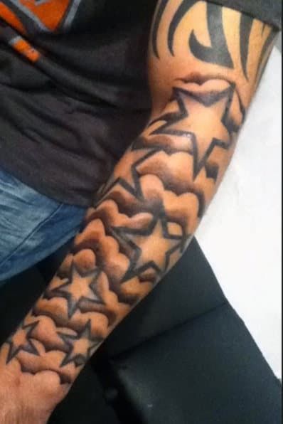 a man's arm with many stars on it