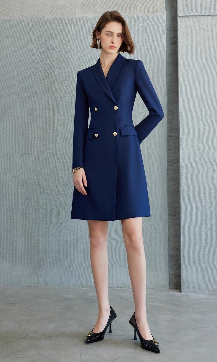 Exude Confidence with the Navy Double-Breasted Blazer Dress Step into a world of refined elegance with our Navy Double-Breasted Blazer Dress—the epitome of power dressing for the modern woman. This dress combines the sharp tailoring of a blazer with the femininity of a dress, creating a look that is both authoritative and elegant. Crafted from high-quality fabric, it features a sleek navy hue, structured shoulders, and gold-tone buttons that add a touch of luxury. The long sleeves and tailored f Elegant Double-breasted Jacket Dress For Spring, Office Wear Notch Lapel Dress With Button Closure, Classic Tailored Dress With Double-breasted Button, Classic Tailored Dress With Double-breasted Button Fastening, Formal Tailored A-line Midi Dress, Classic Tailored Double-breasted Dress, Winter Formal Dresses With Buttons, Chic Fitted Blazer Dress For Career, Notch Lapel Dress With Button Closure For Work