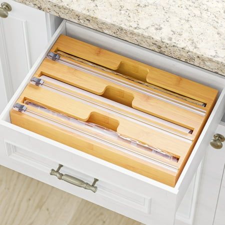 an open drawer in a kitchen next to a counter